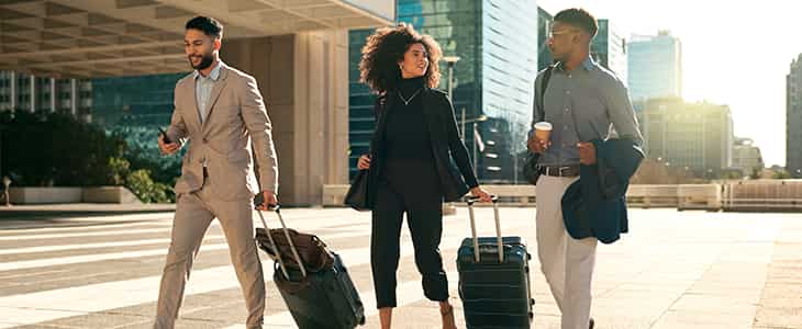 business people walking out of hotel to bus